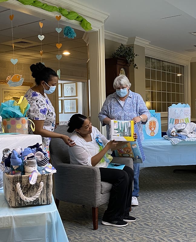 Staff and residents celebrating with gifts and decorations