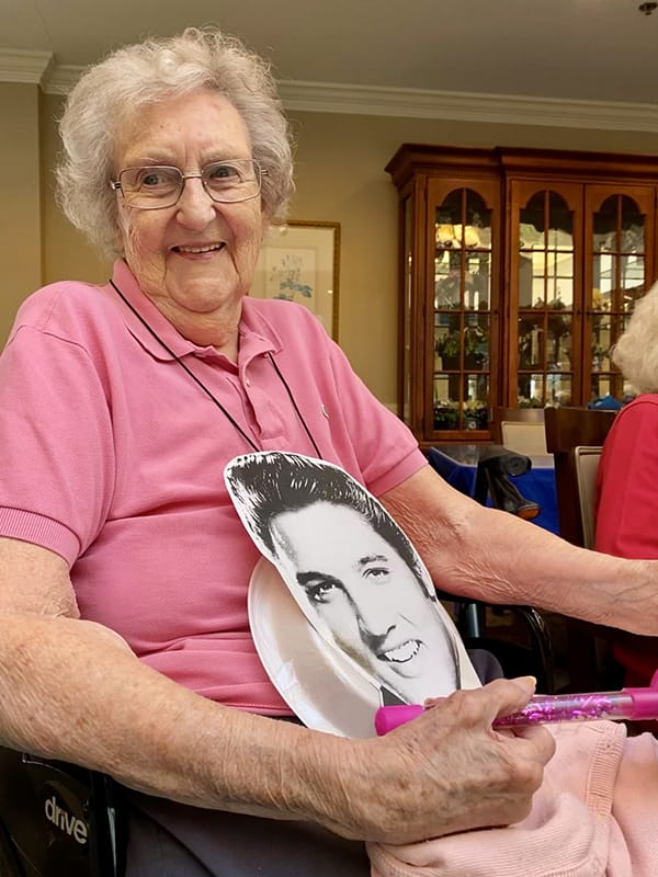 Resident engaging in a fun activity with a celebrity cutout
