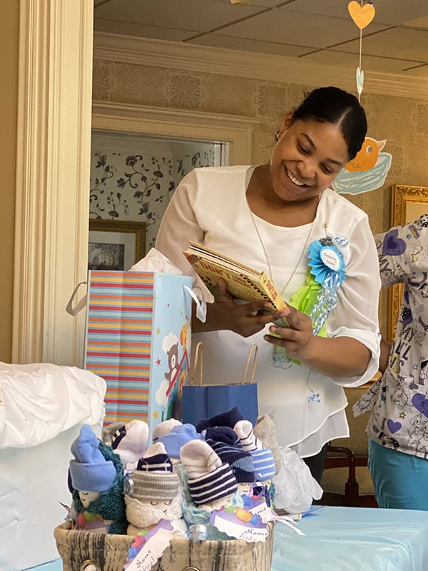 Staff member at a celebration with gifts