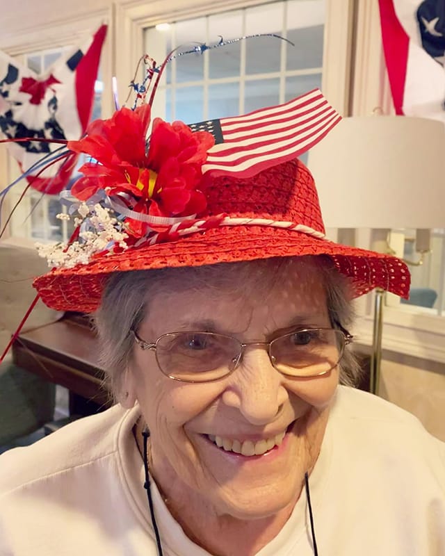 Resident wearing a festive red hat with decorations