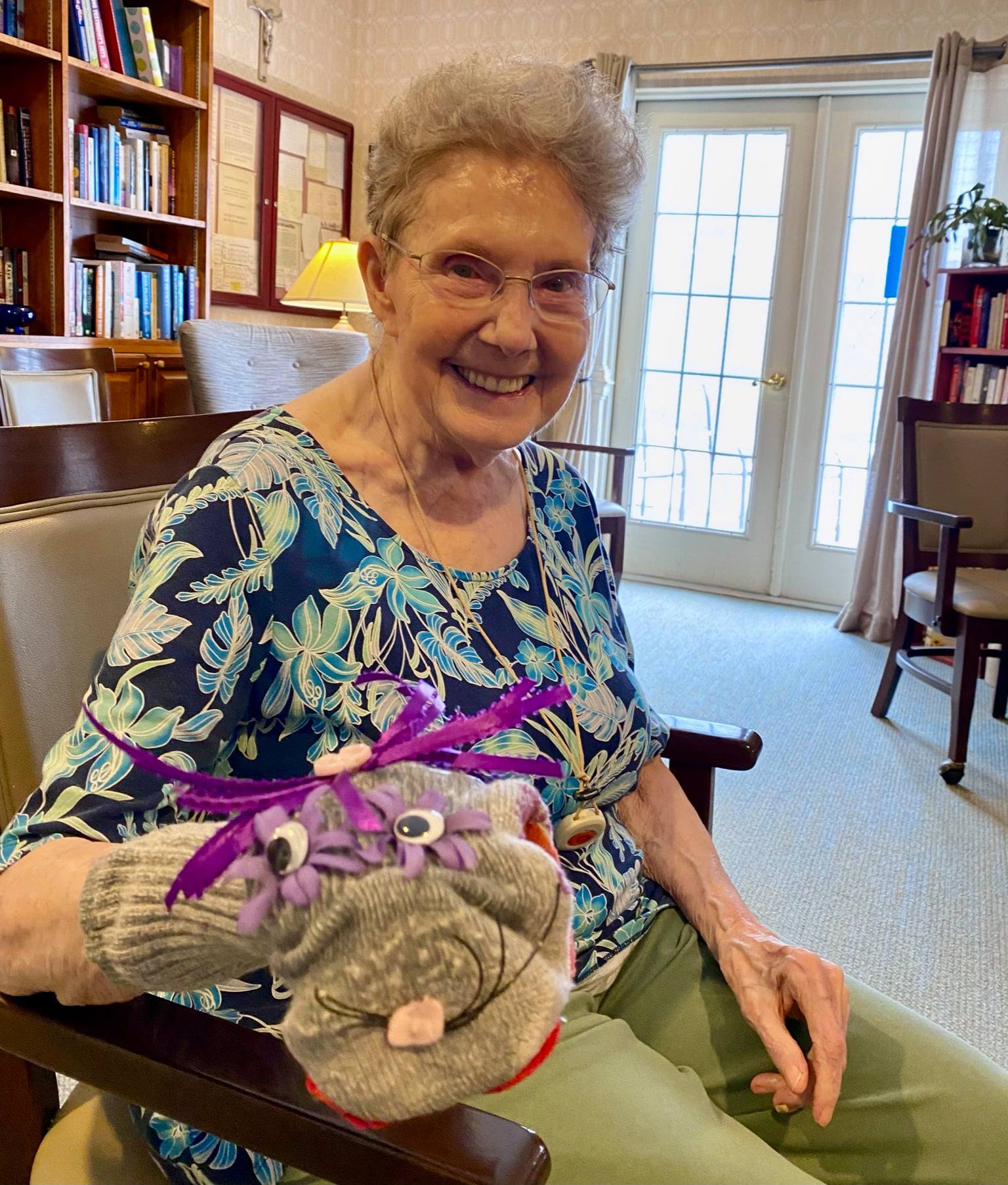 Resident enjoying a creative activity with a puppet