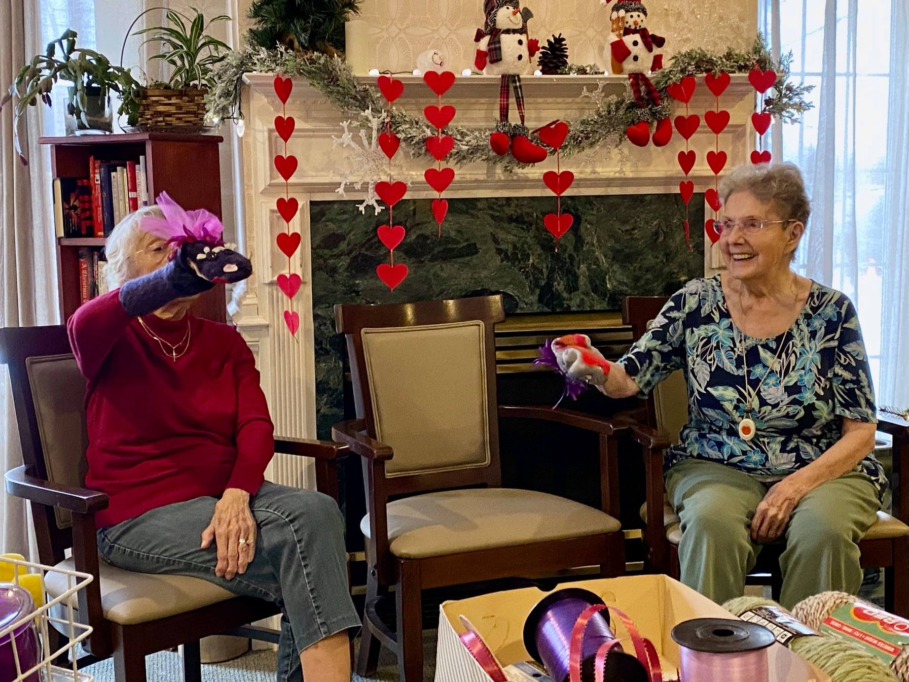 Two residents engaging in an activity in a common room