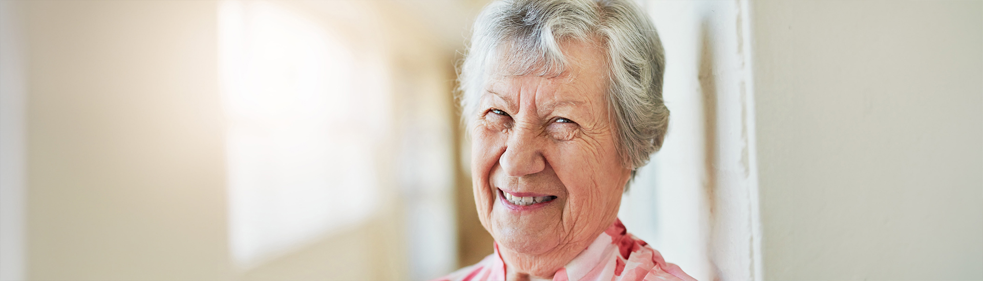 Smiling resident in a corridor of the facility