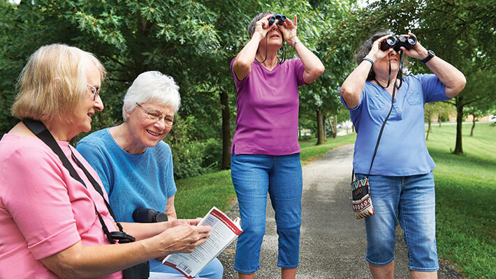Residents enjoying birdwatching on a path
