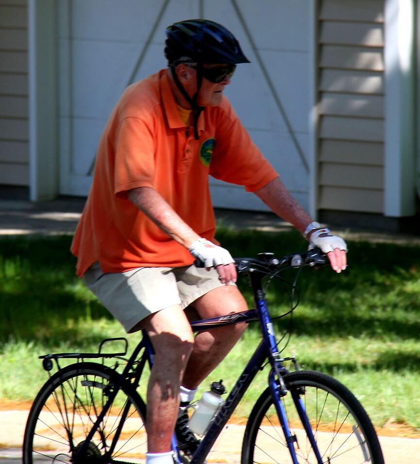 Senior man riding a bicycle outdoors
