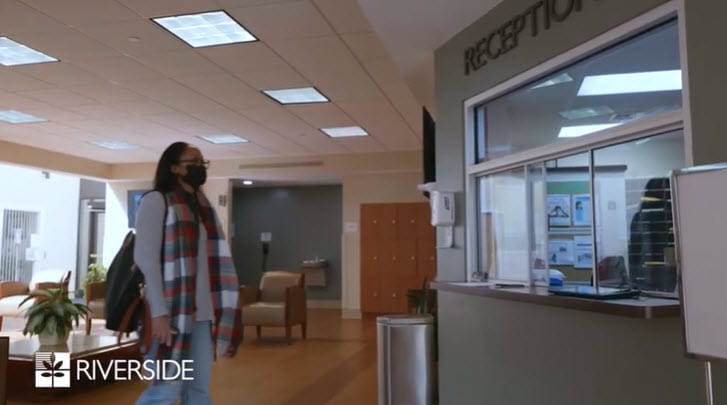 Woman at the reception desk in a facility lobby