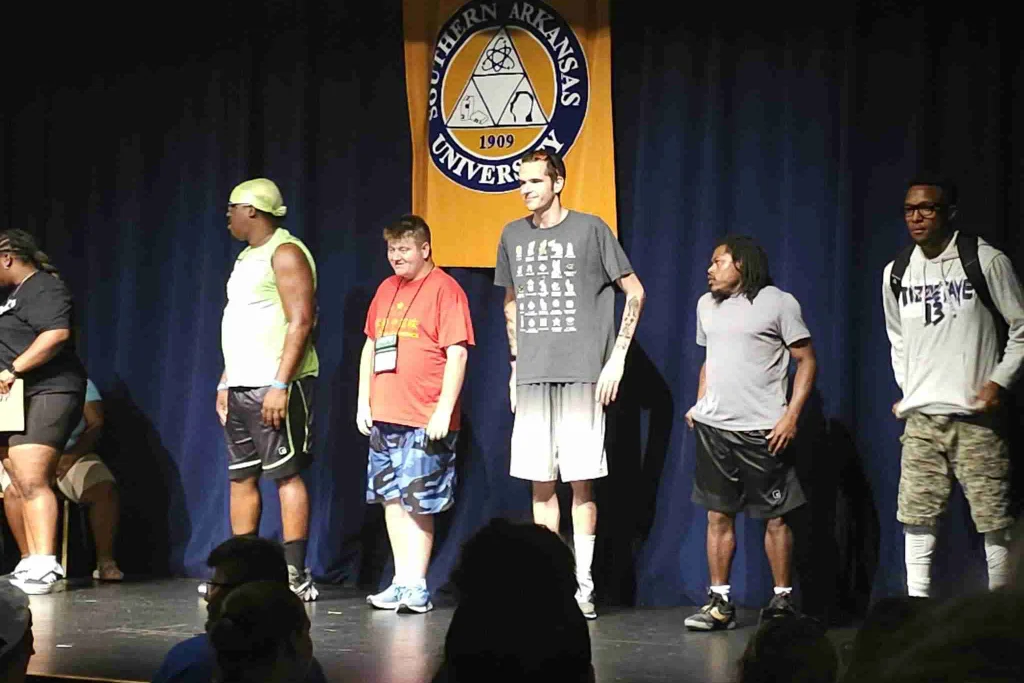 Various people standing on stage at an event
