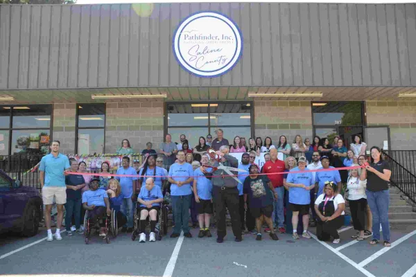 Group of residents and staff outside the facility during a ribbon-cutting event