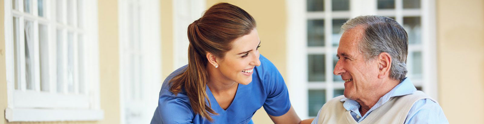 Caregiver interacting with a resident in a cheerful moment