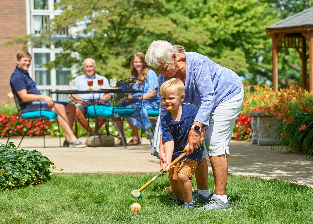 Residents enjoying croquet in a garden area