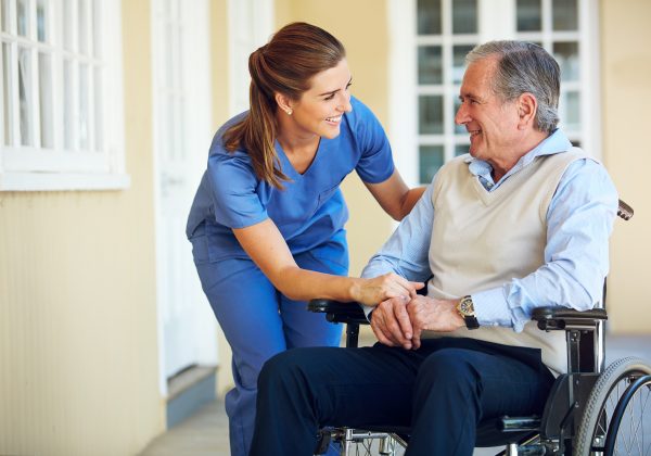 Nurse assisting a resident in a wheelchair