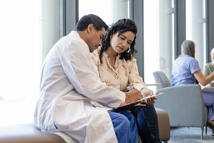 Doctor consulting with a resident in a bright lounge