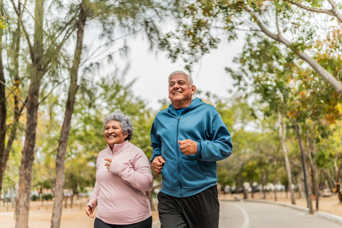Elderly couple jogging in a park