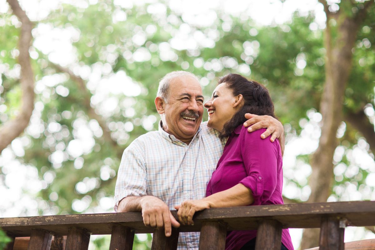 A couple enjoying a moment outdoors in a park setting