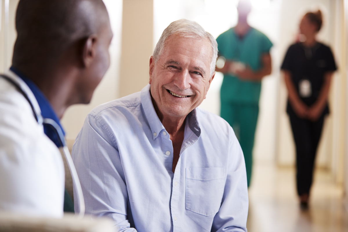 Senior resident smiling during a conversation with staff