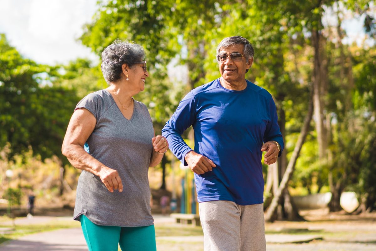 Two seniors walking in a park