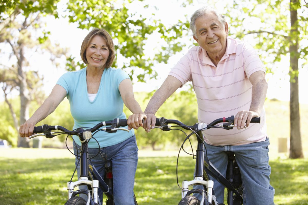 Seniors enjoying a bike ride in a park