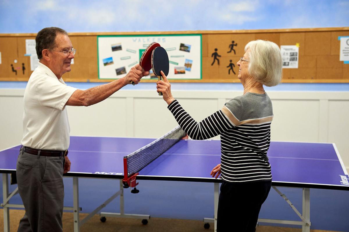 Residents playing ping pong in an activity room