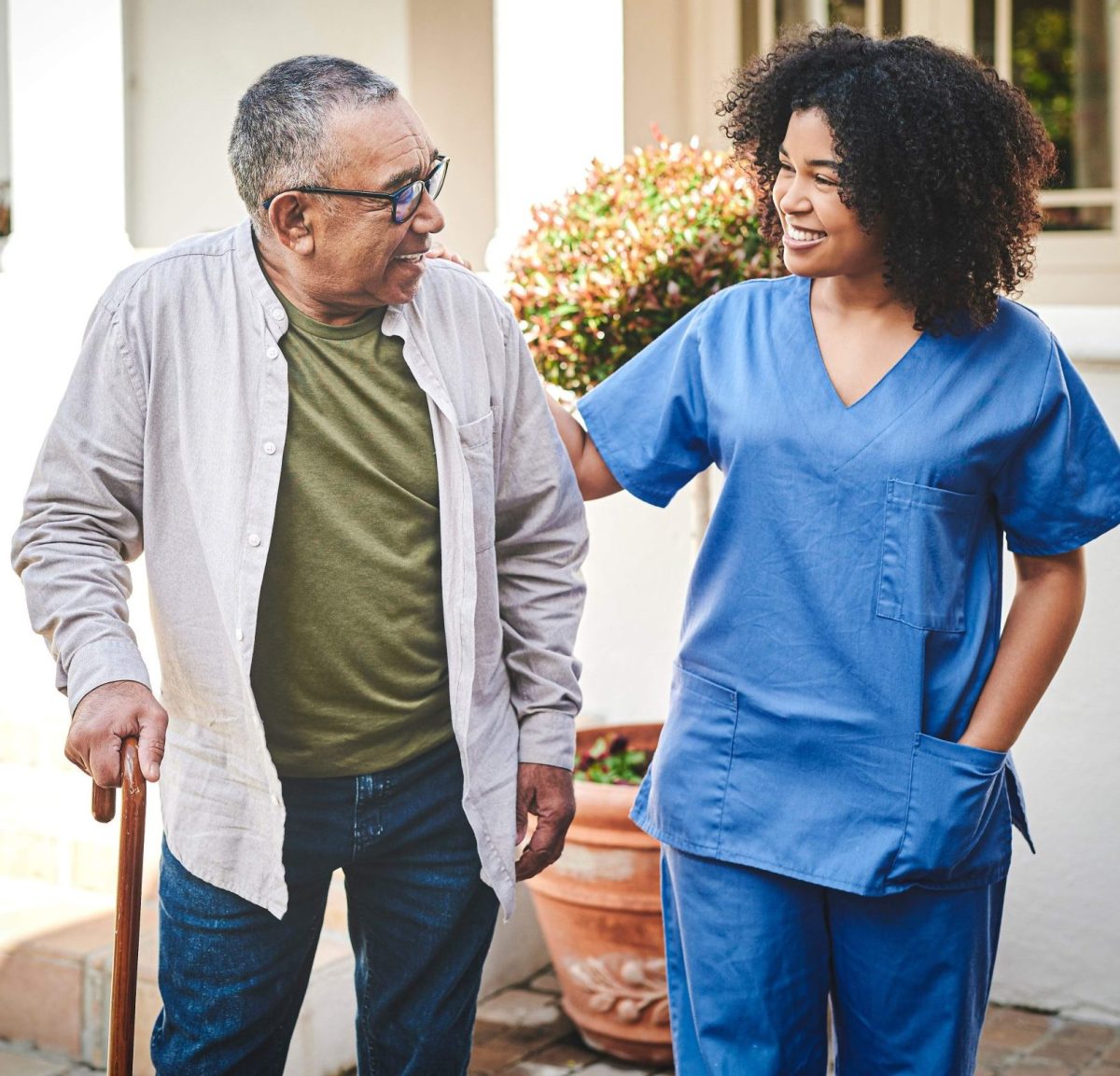 A caregiver assisting an elderly resident outside