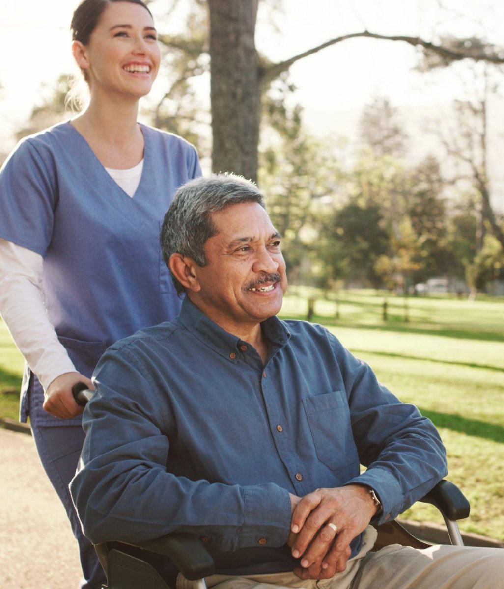 Caregiver assisting a resident in a park
