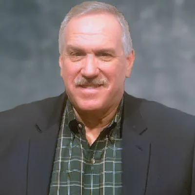 A man in a suit smiling at the camera