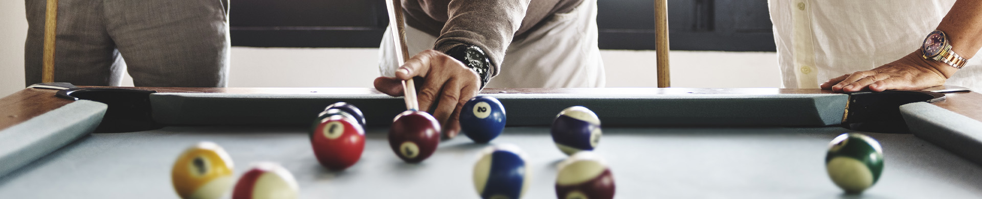 Residents playing billiards in an activity room