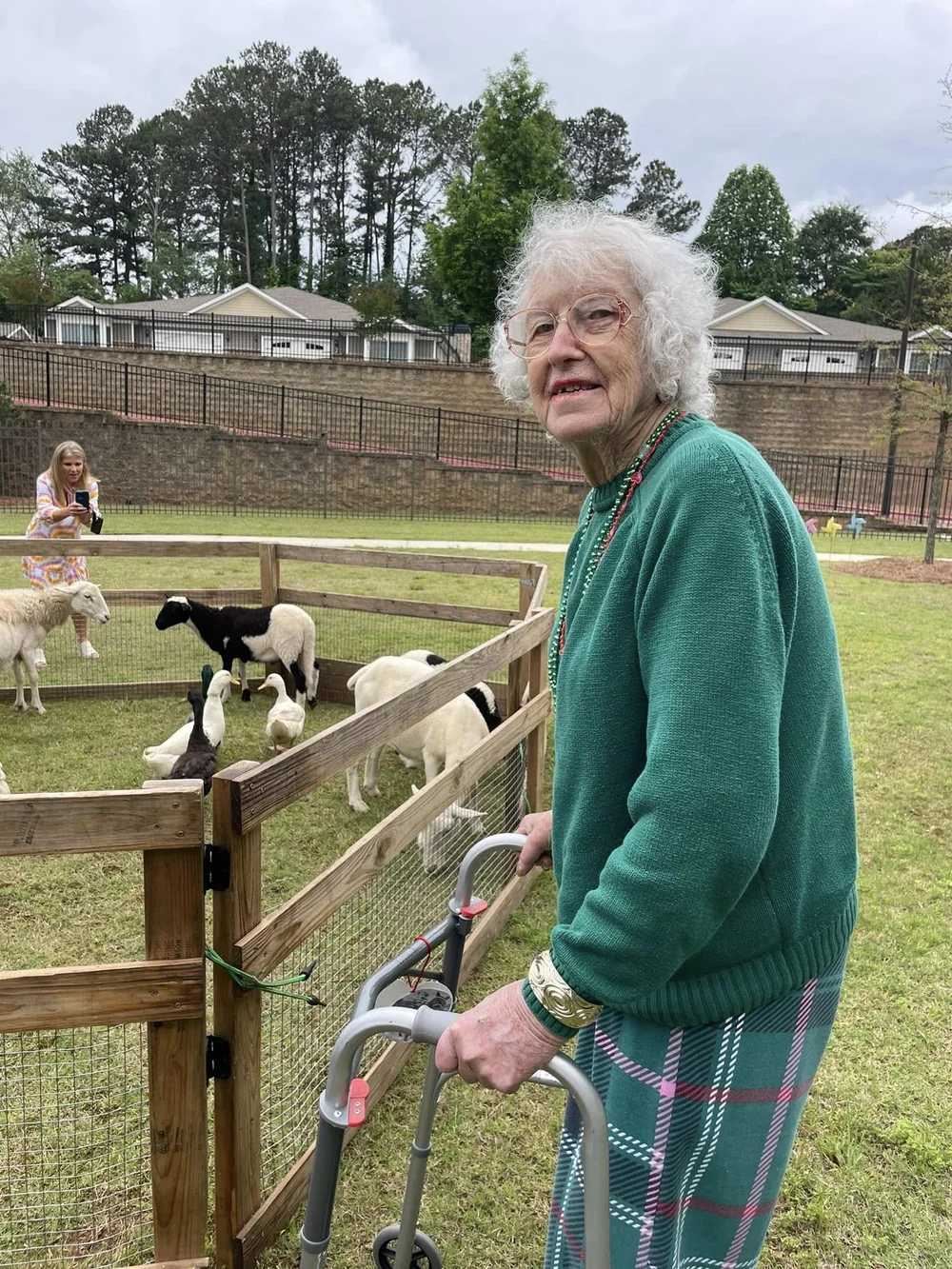 Resident interacting with animals in an outdoor space