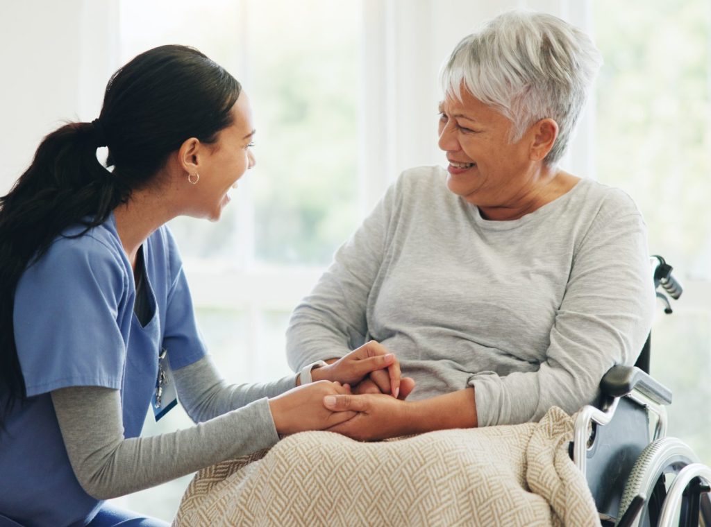 Caregiver and resident sharing a joyful moment