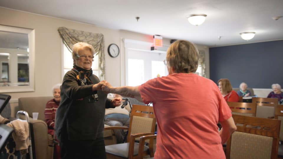 Residents dancing together in a common area