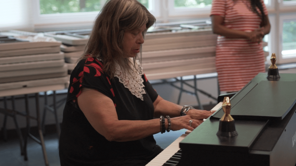 Resident playing piano during a community event