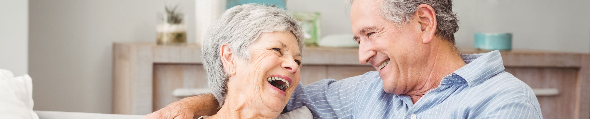 Laughing couple enjoying each other's company indoors