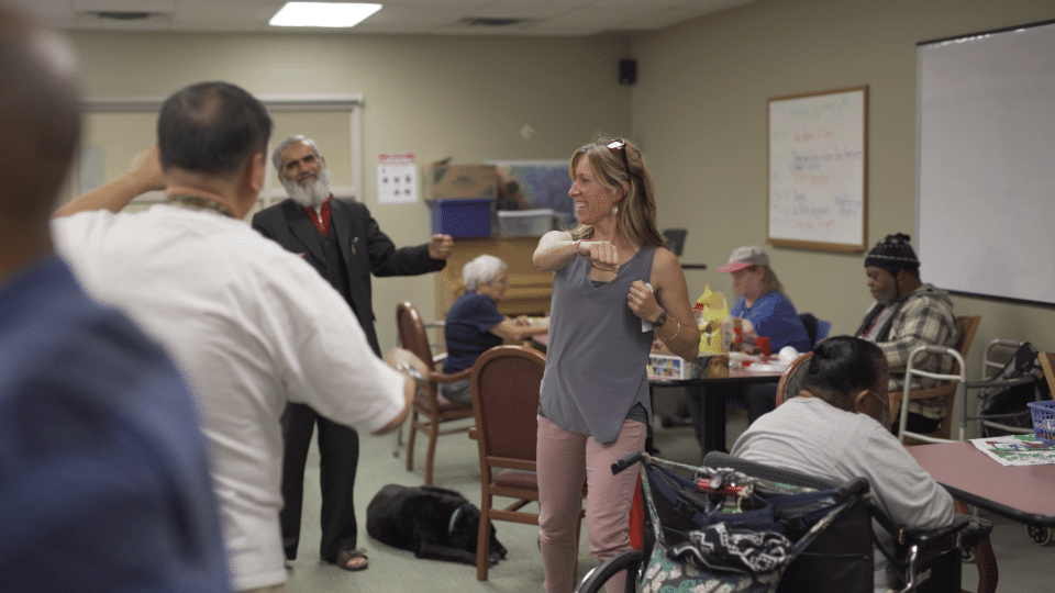 Residents participating in a movement activity in a common area