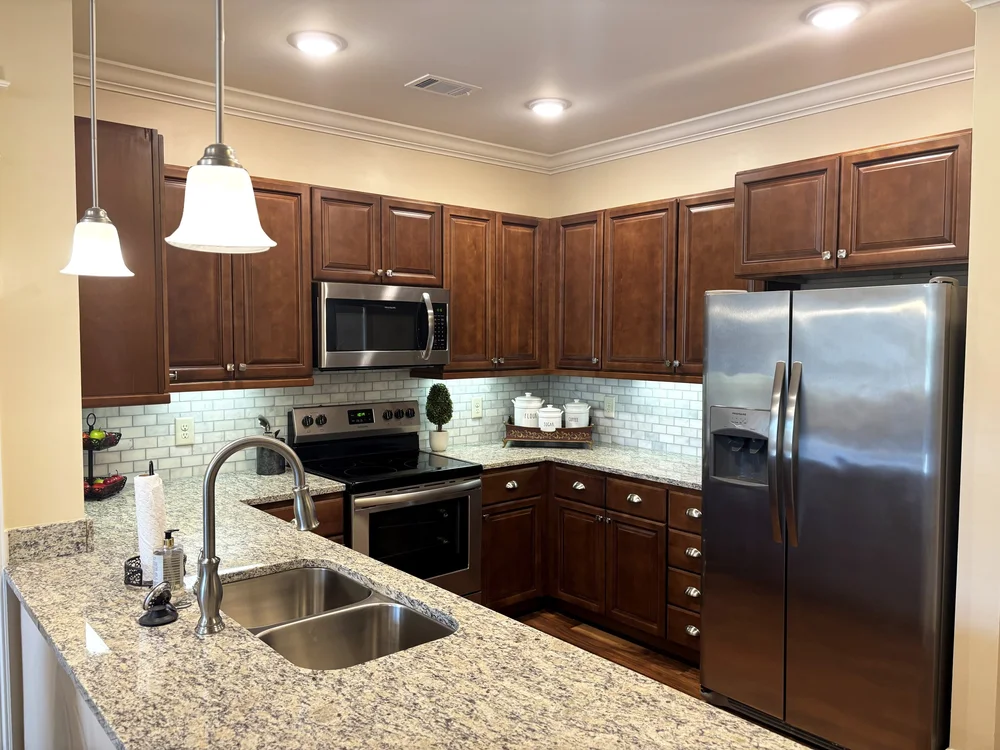 Modern kitchen with granite countertops and appliances
