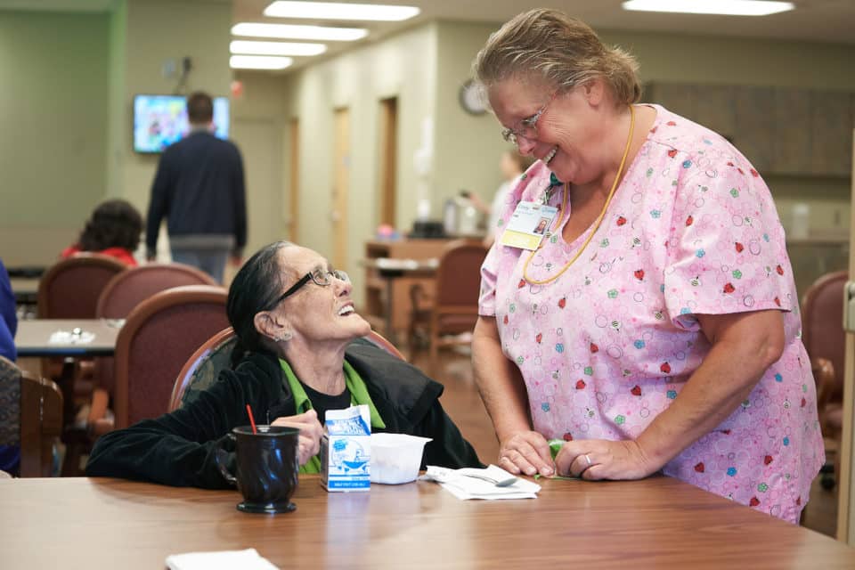 Staff member chatting with a resident in a common area