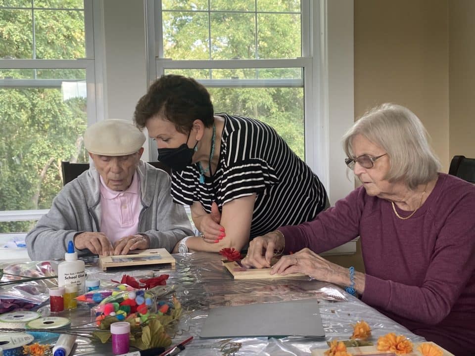 Residents and staff engaged in a craft activity