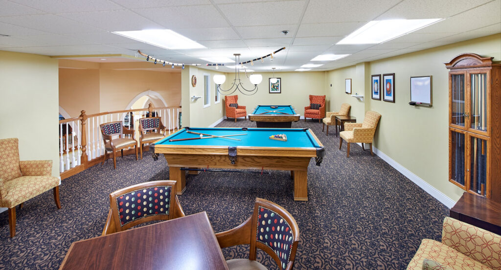 Interior view of a recreational game room with pool tables