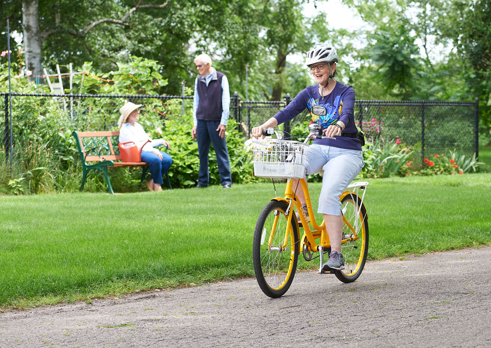 Resident enjoying a bike ride in the garden