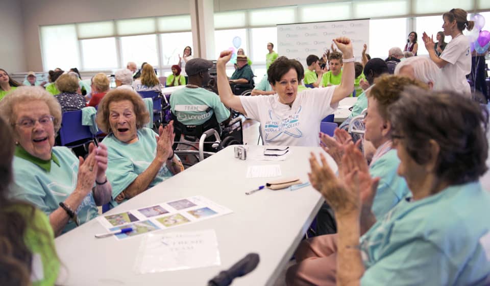 Residents and staff enjoying a lively activity together