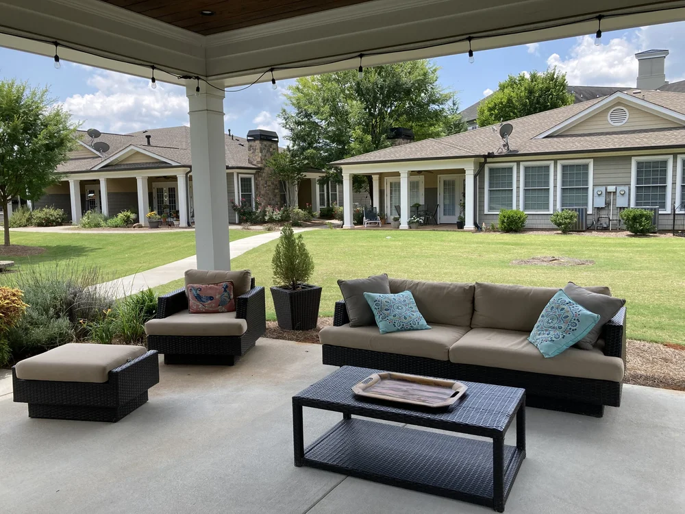Outdoor seating area with comfortable couches and garden views