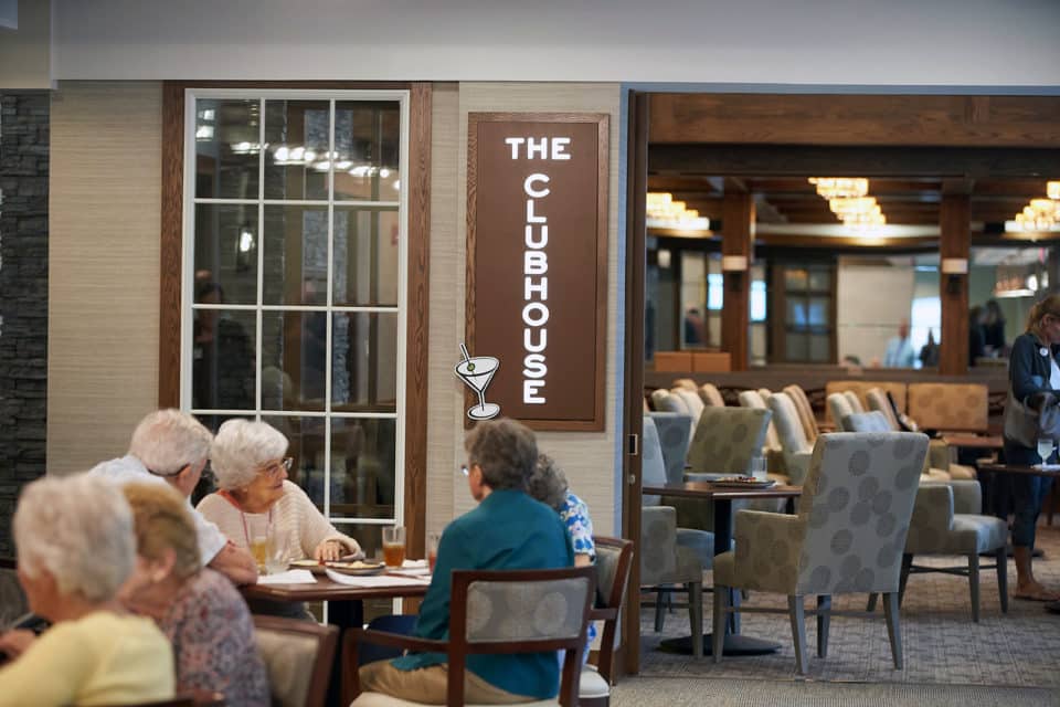 Residents socializing in the dining area of the clubhouse