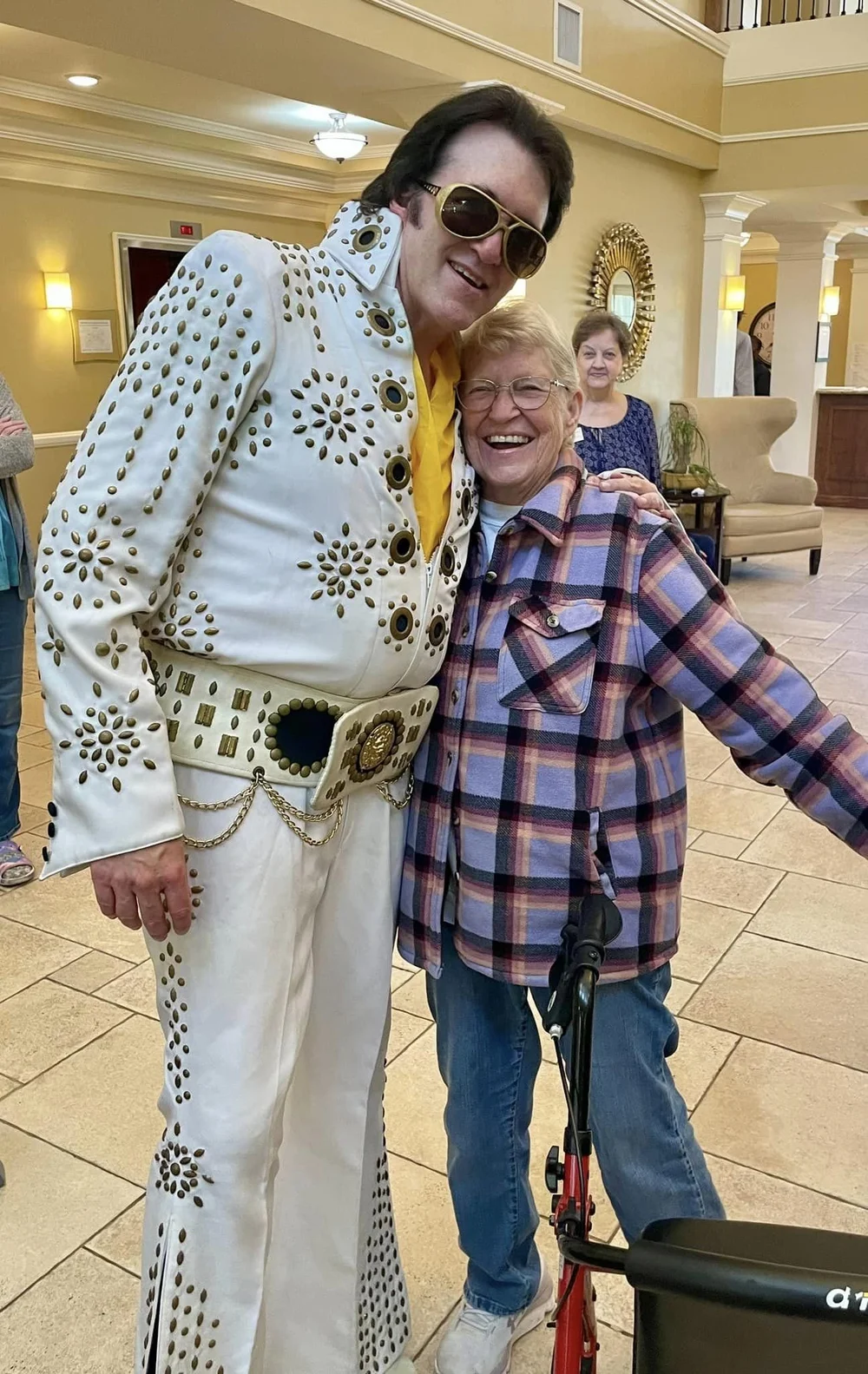 Resident posing with performer in a common area