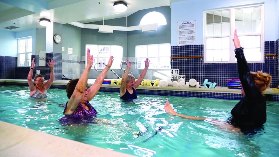 Residents participating in a water exercise class