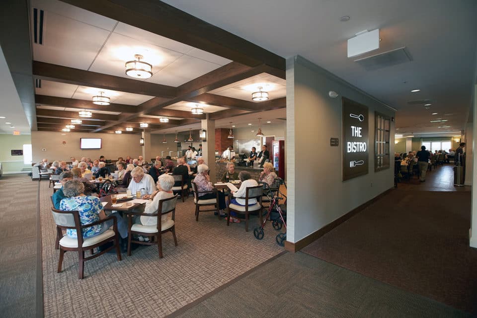 Residents dining in a communal bistro area