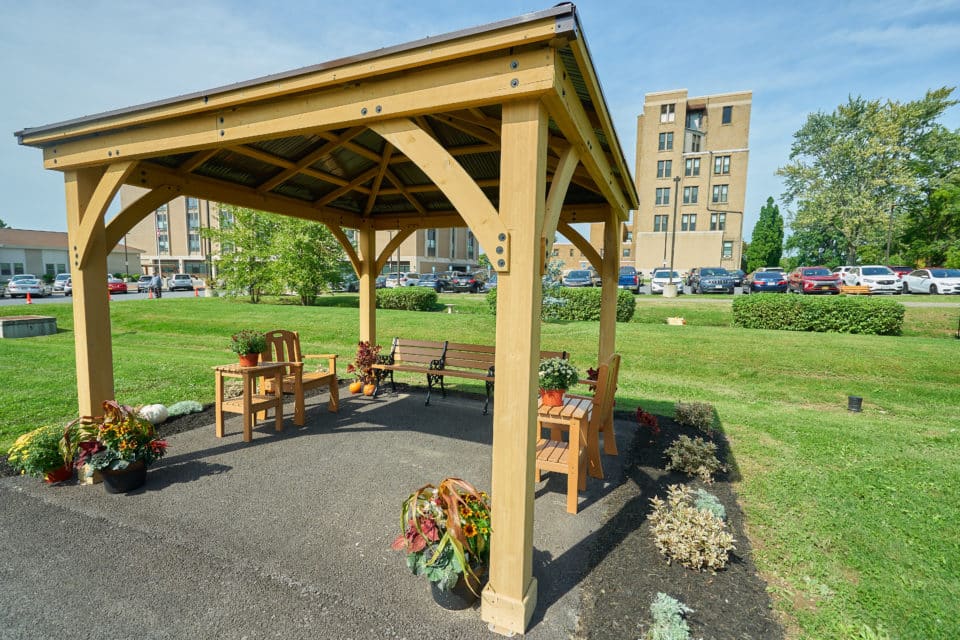 Outdoor gazebo area with seating and landscaping