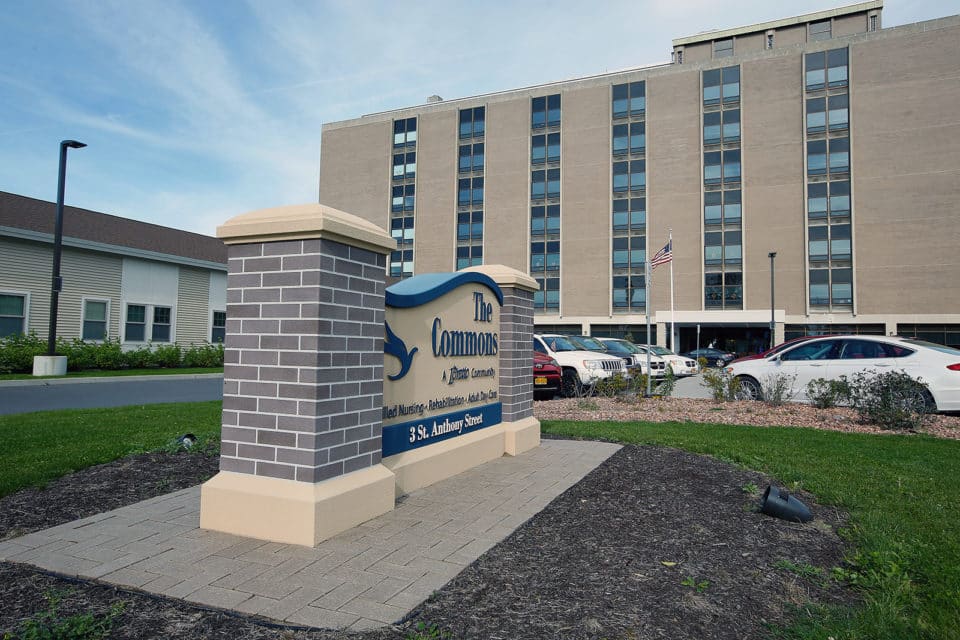 Exterior view of The Commons residence with signage