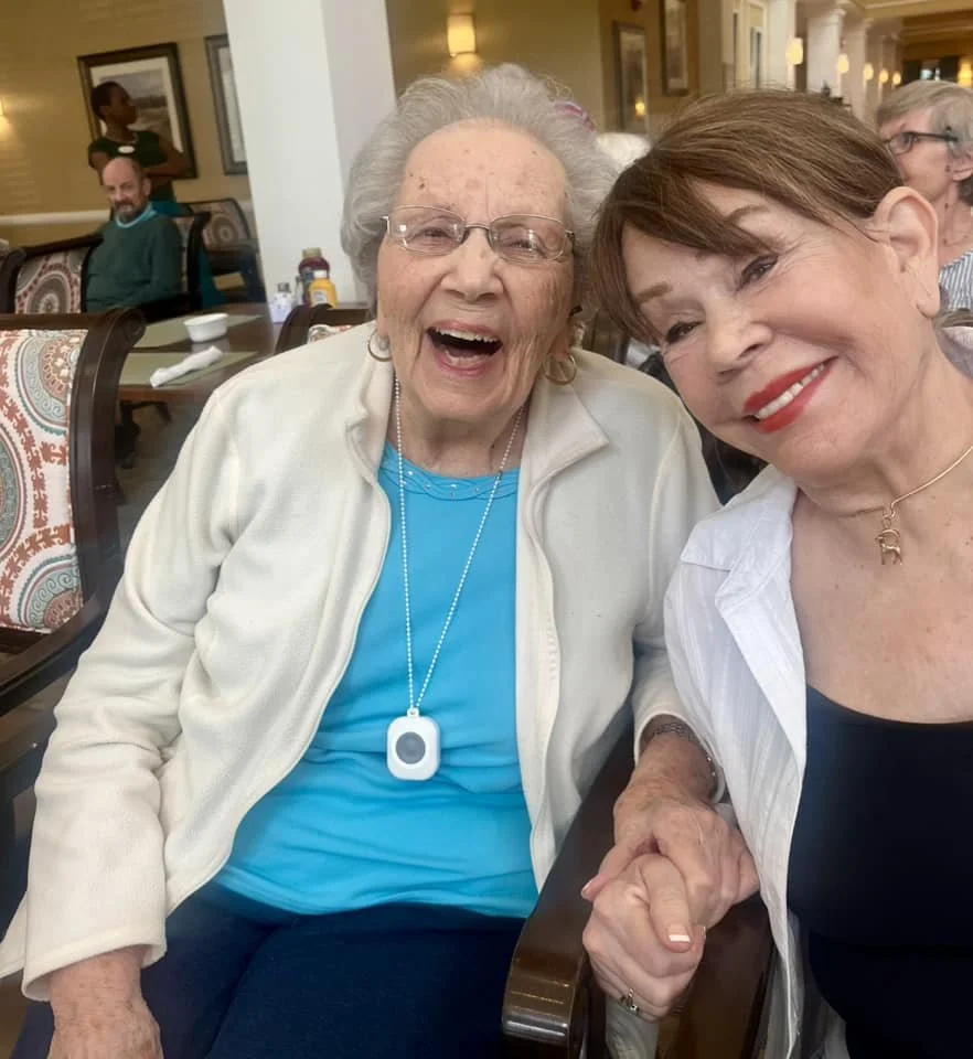 Two smiling residents in a communal area