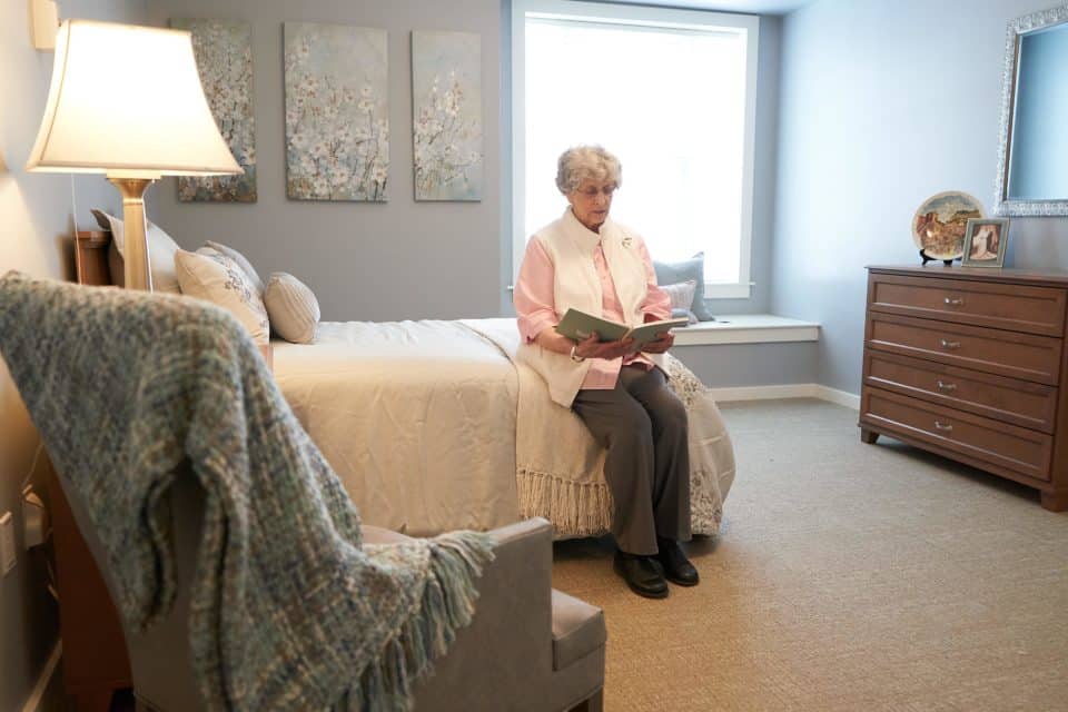 Senior resident reading in a cozy bedroom