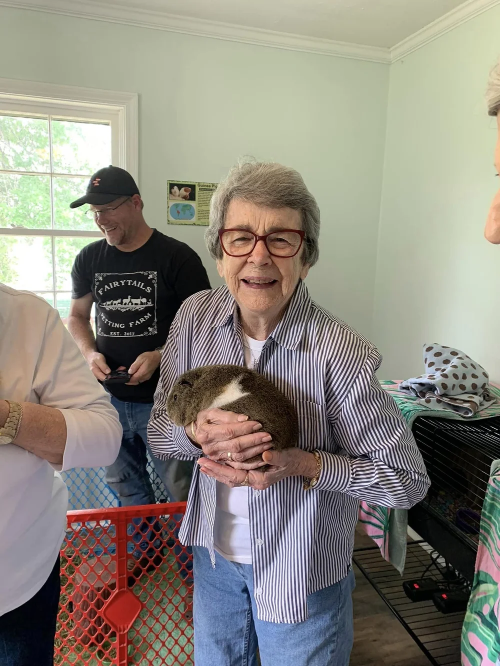 Resident holding a small pet during a social event