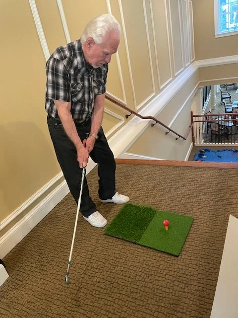 Resident enjoying a golf activity indoors
