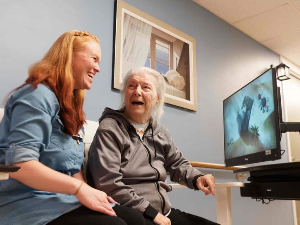 Resident engaging with a staff member in the facility